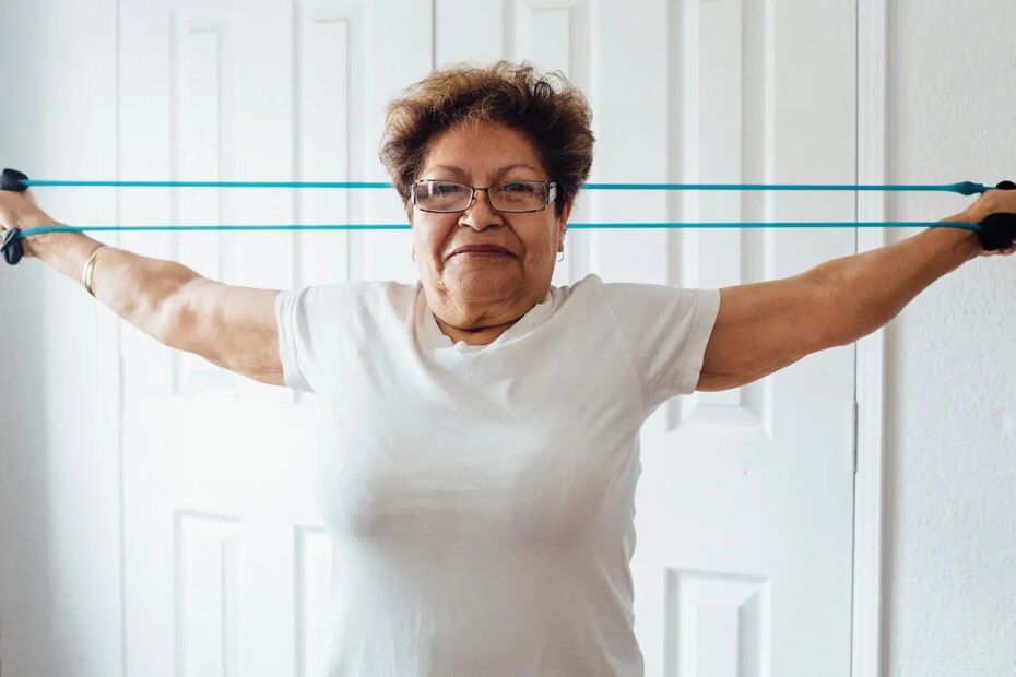 A photo of a senior woman exercising with a resistance band.