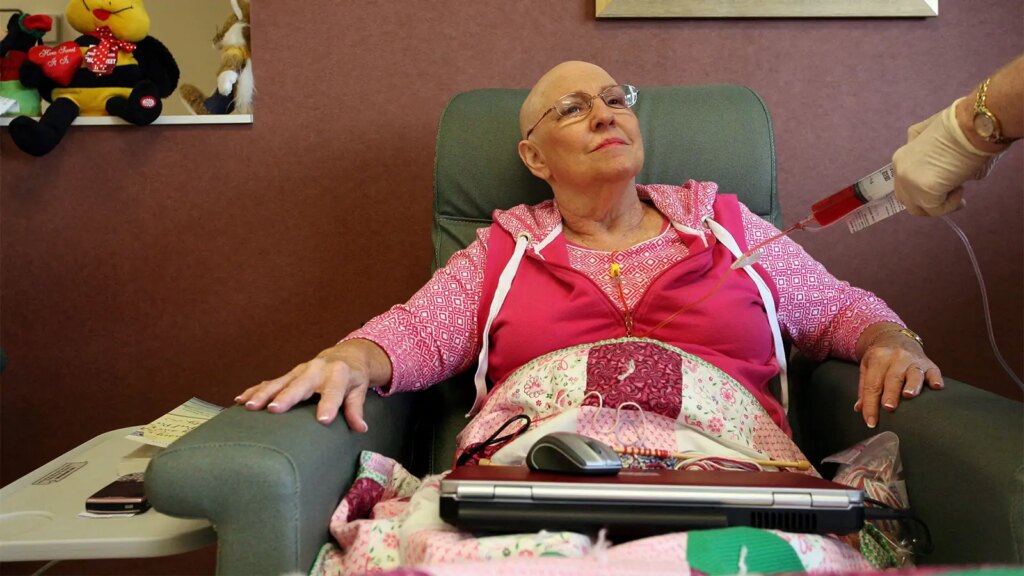 A photo of a senior woman receiving chemotherapy.