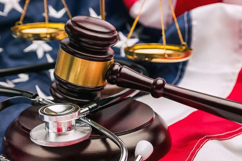 Gavel, stethoscope and scale on national flag of USA.