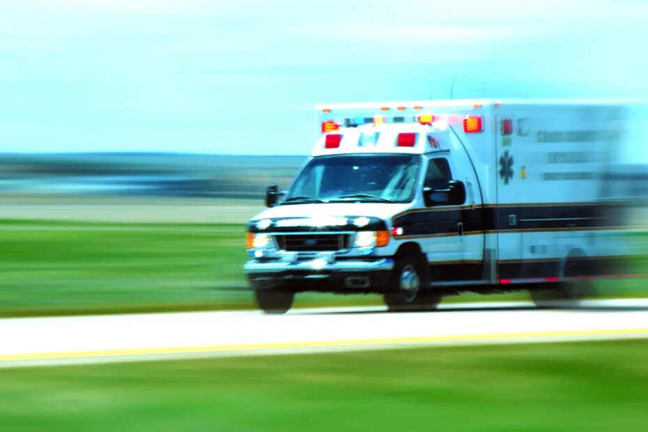 A photo of an ambulance driving down a highway.