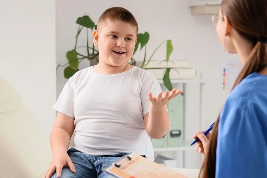 A photo of a boy speaking to a female physician in a clinic.